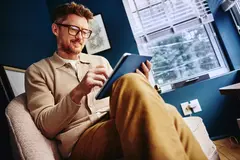 a man reading from a tablet