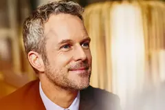 Close up - Smiling male looking away.
