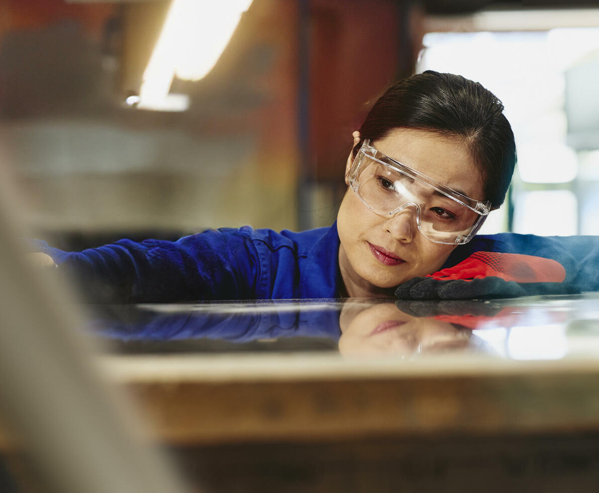 Womale wearing safety glasses and gloves watching a process closely.
Womale wearing safety glasses and gloves watching a process closely.